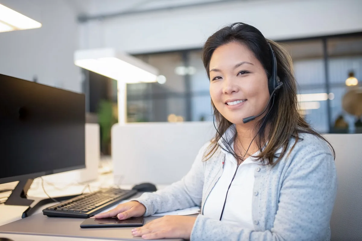 customer support agent with telephone headset computer