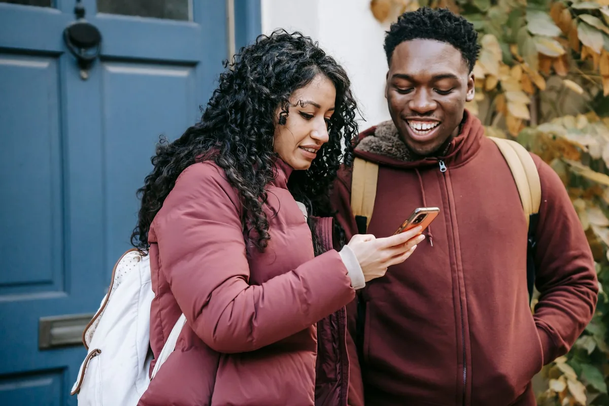 young tourists checking mobile phone travel app