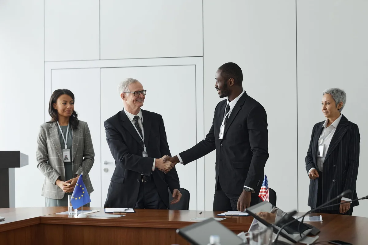 business executives shaking hands in a boardroom