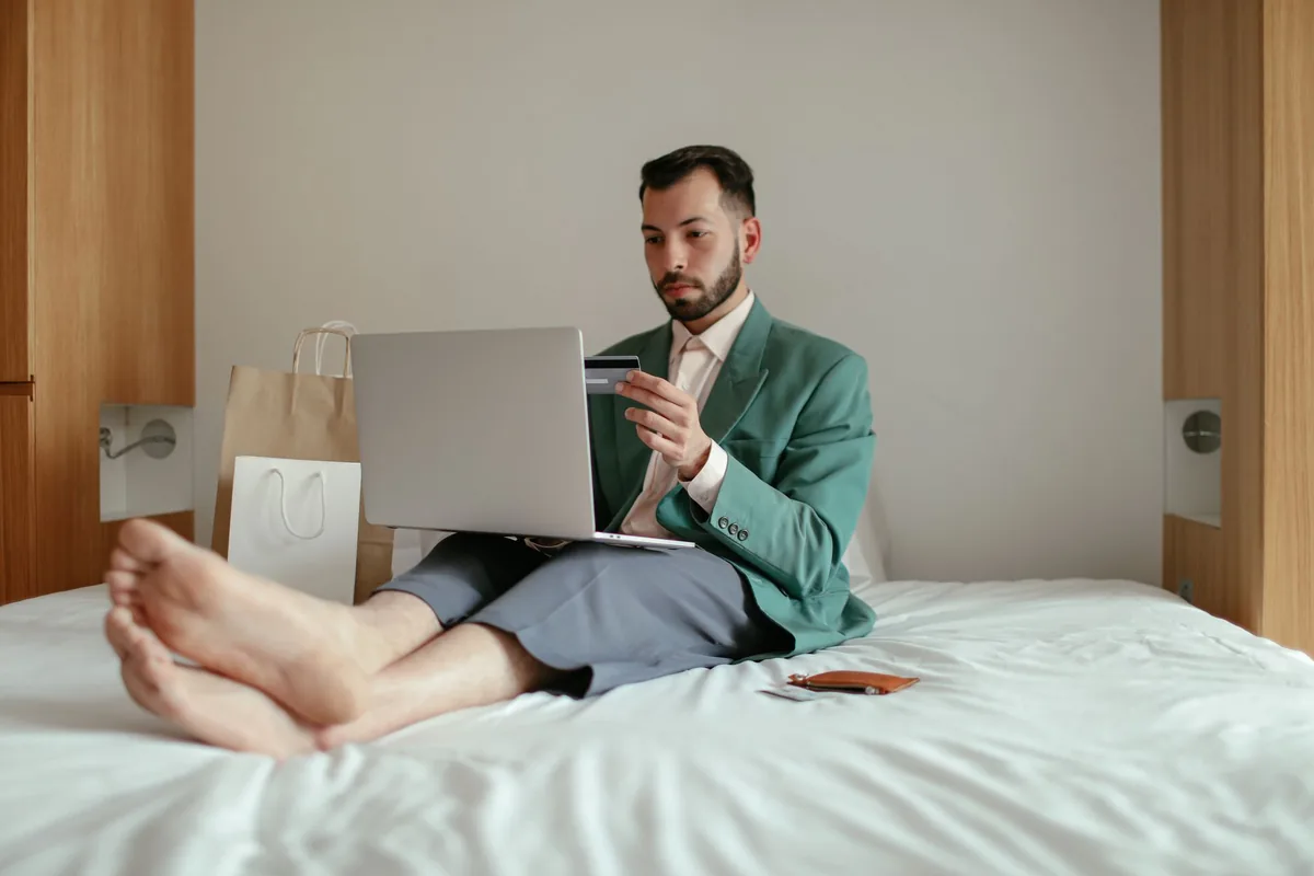 traveler using laptop credit card hotel room