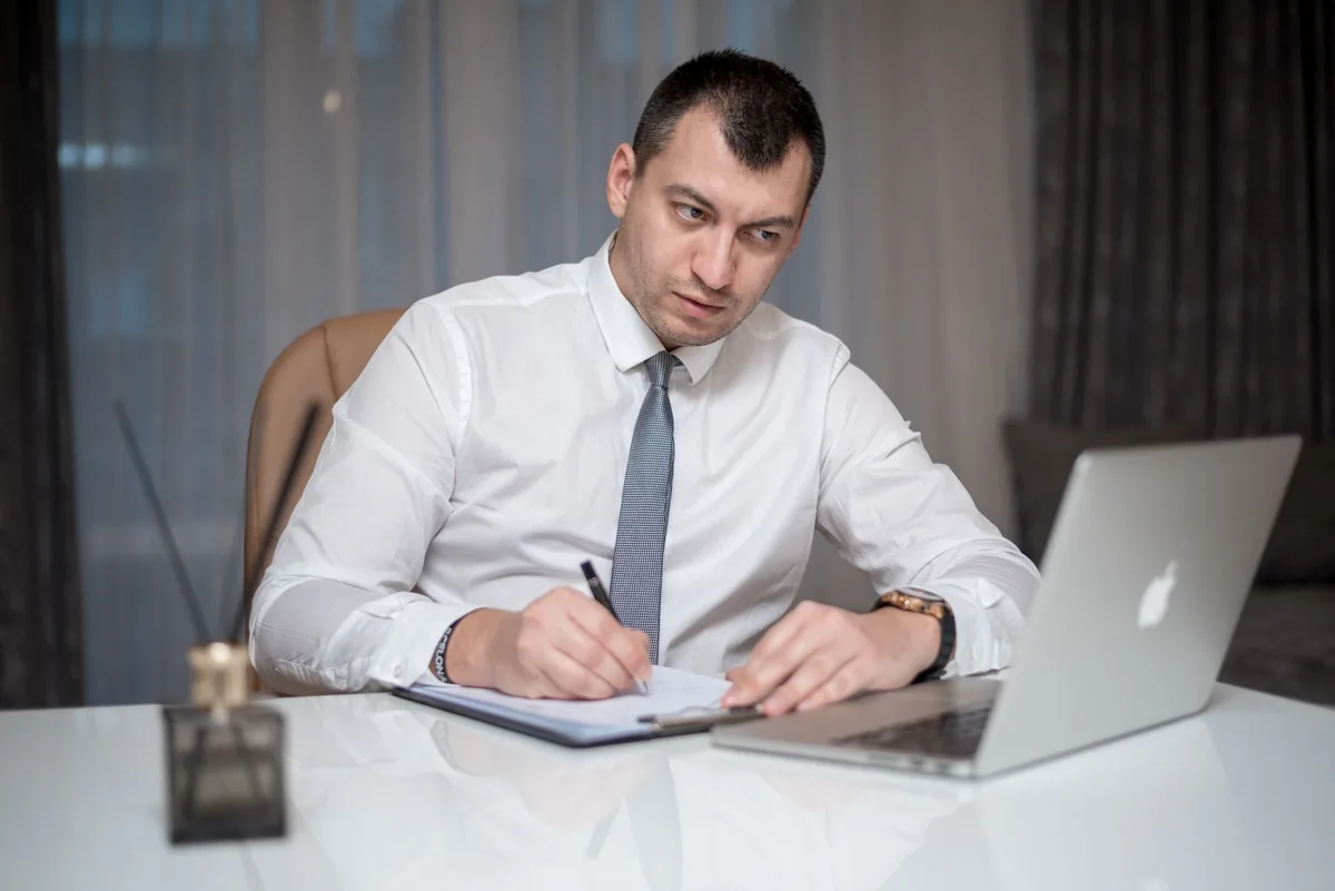 hotel executive looking at laptop screen