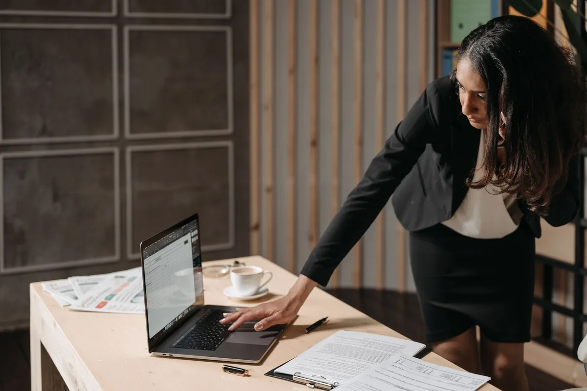 hotel manager using laptop front desk