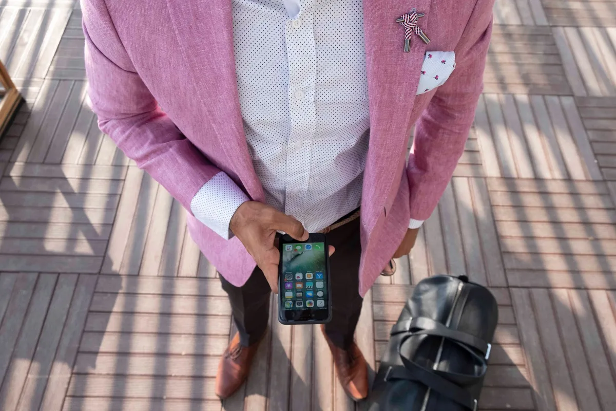 traveler using smartphone app in airport lobby