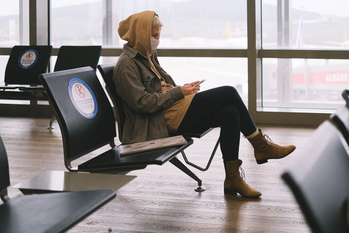 passenger using smartphone in airport lounge