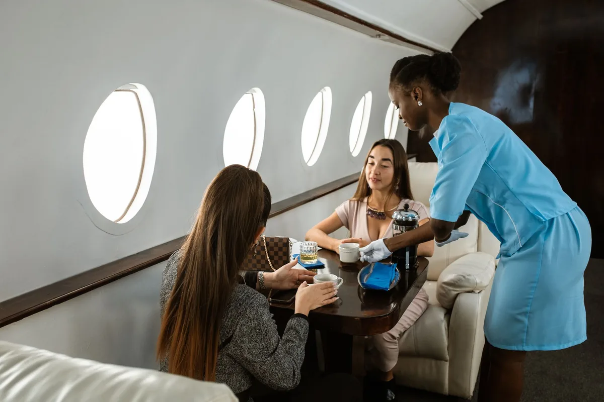flight attendant serving business class cabin