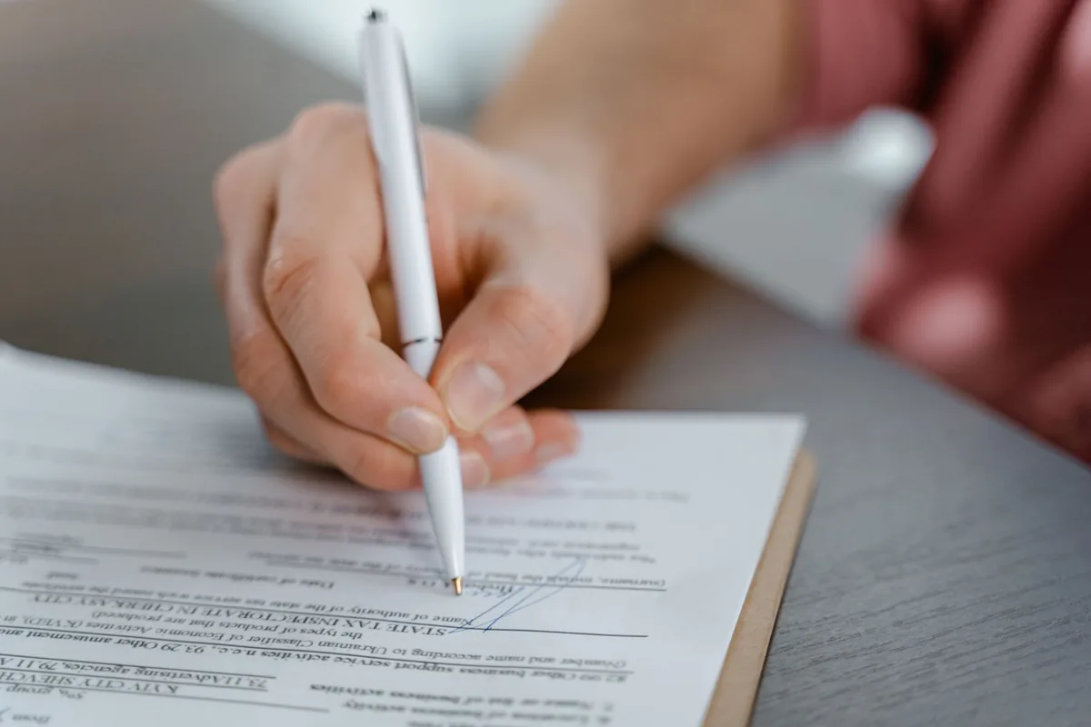 business executives signing legal documents