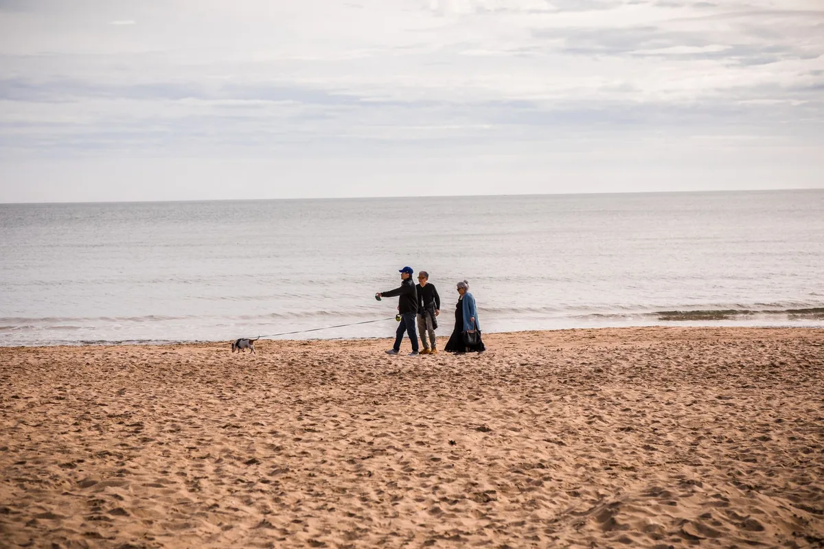 tourists walking along british beach