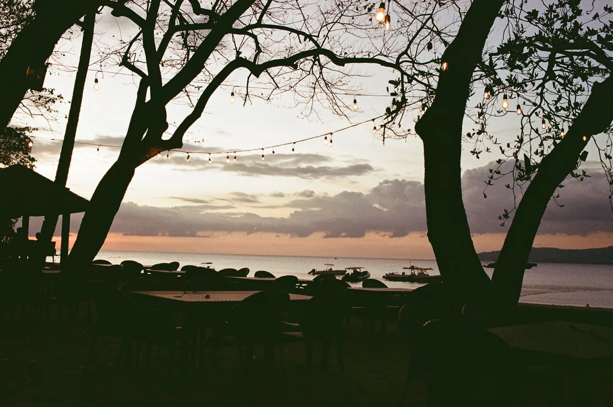 tropical beach dining table set at dusk