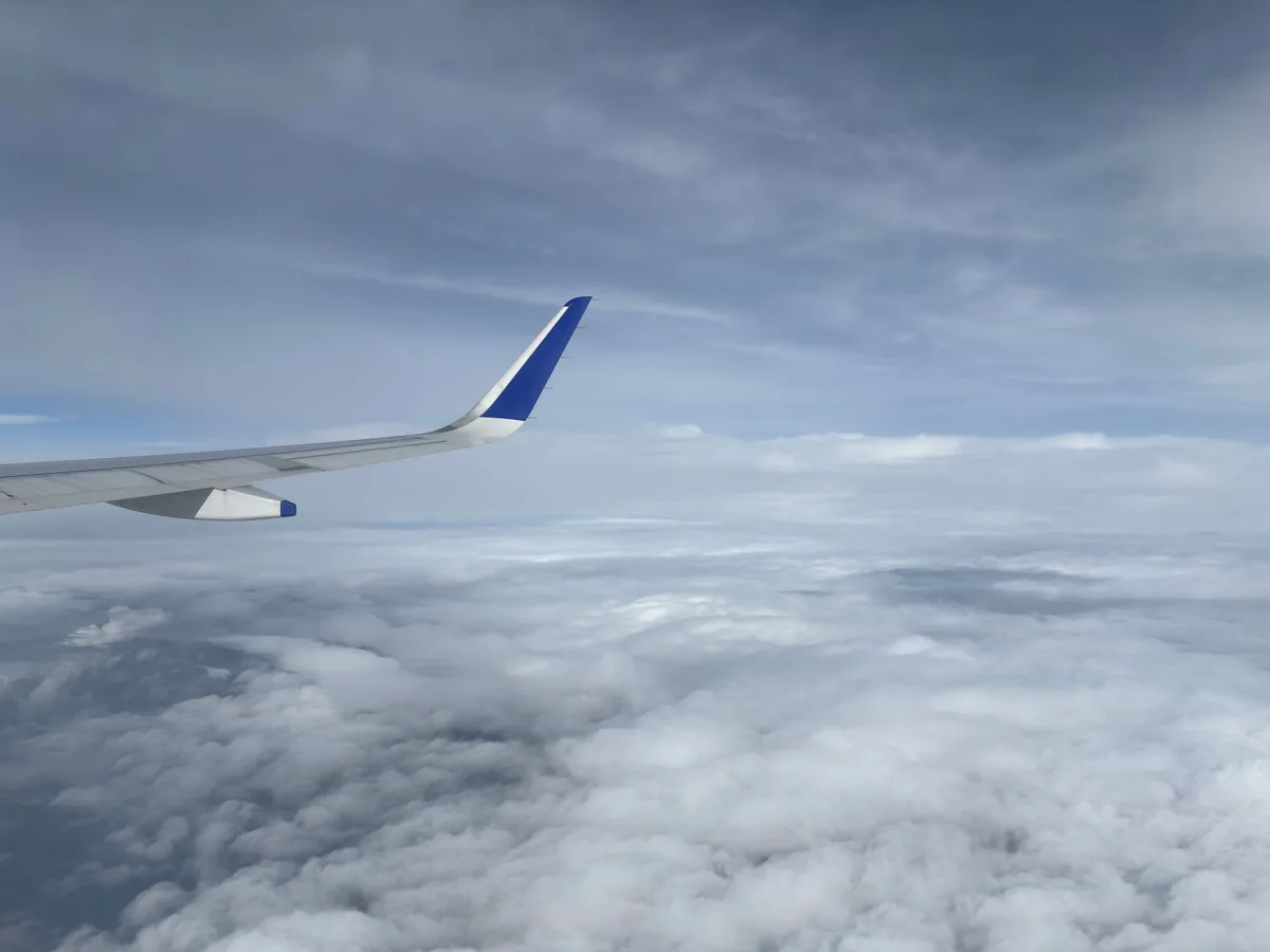 airplane flying over clouds
