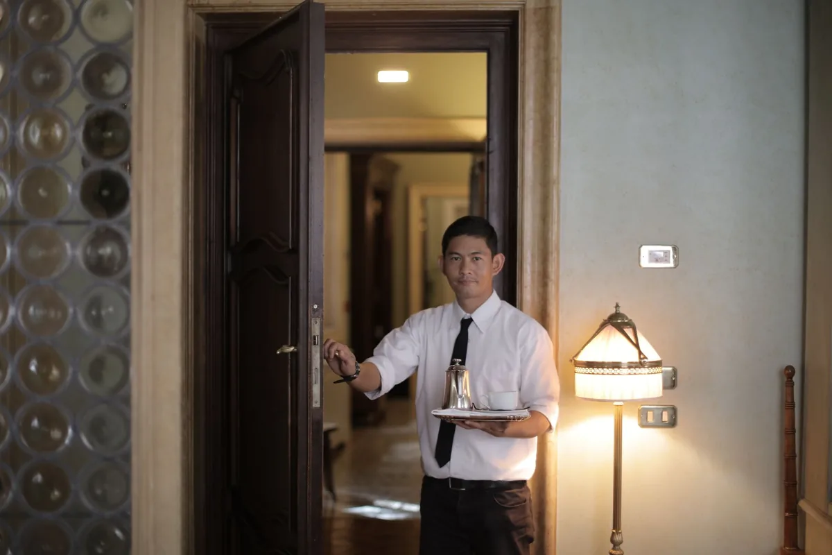 hotel bellhop opening entrance doors