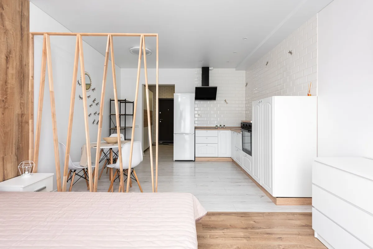 hotel studio room with small kitchen and dedicated workspace