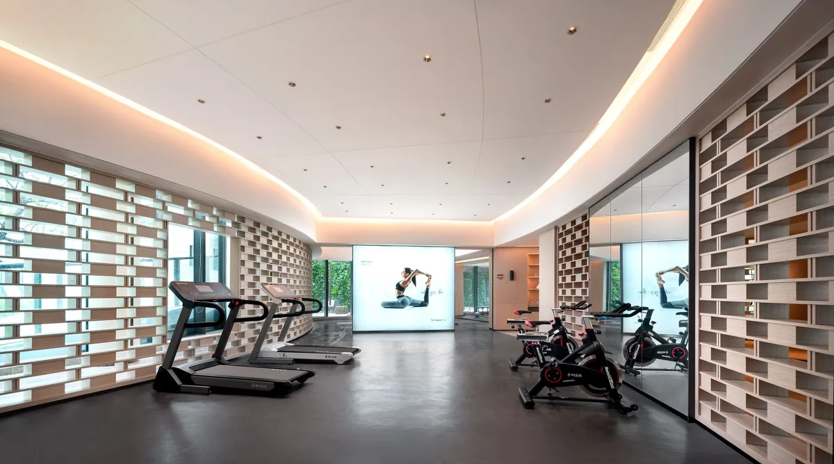 hotel fitness center with health club equipment and treadmills