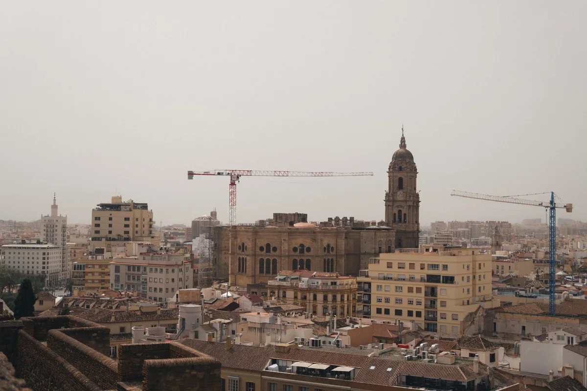 construction crane skyline over a historic city neighborhood