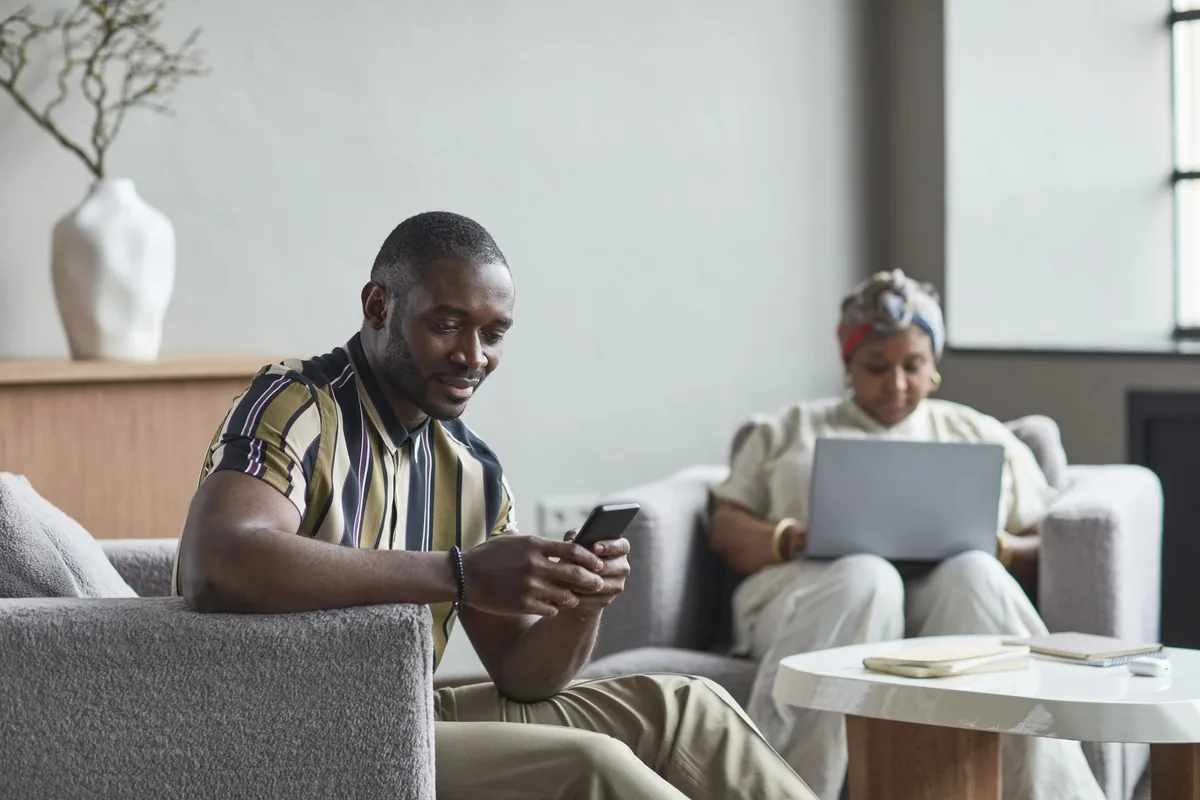smartphone displaying a hotel destination guide held by a person sitting in a modern lobby