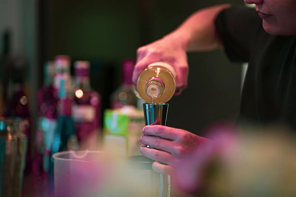 bartender crafting botanical nonalcoholic cocktail