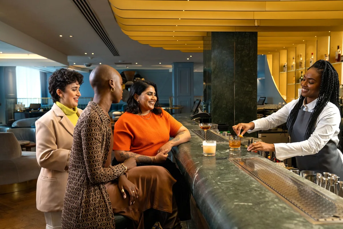 artisanal cocktail on a bar counter in a vibrant hotel lounge