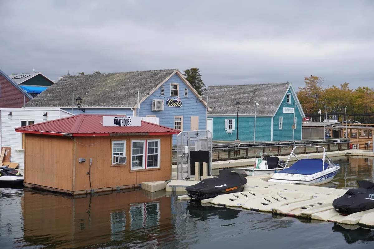 waterfront dock with jet skis parked near a resort