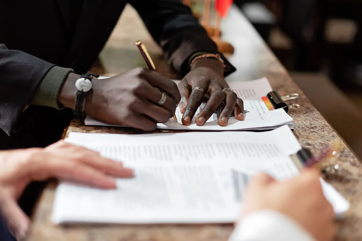 hotel executive signing contract at desk