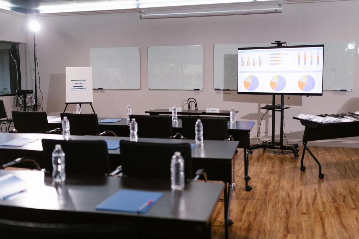 hotel meeting room setup with chairs facing a presentation screen