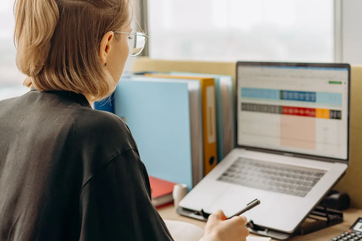 hotel manager looking at computer screen in back office