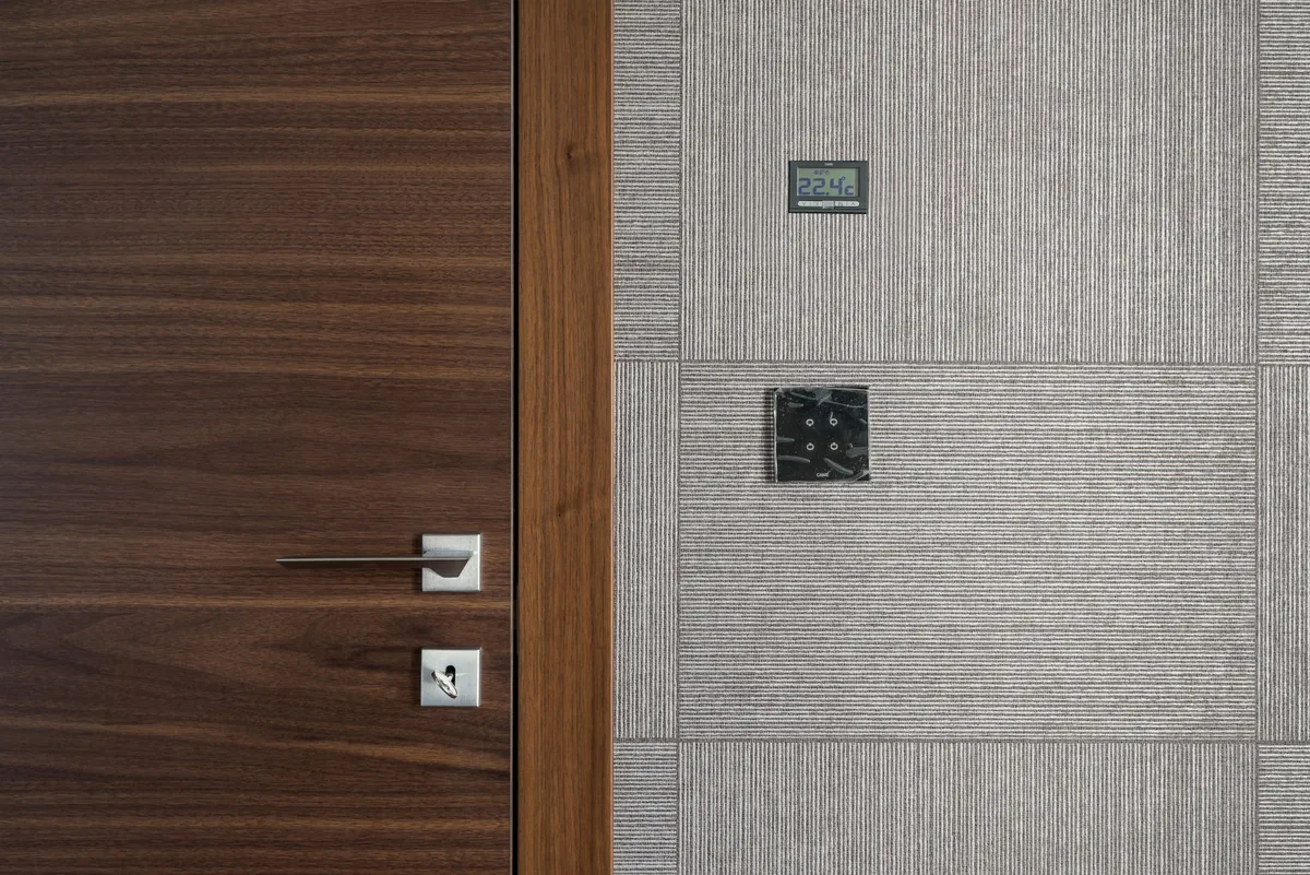 close up of a modern hotel thermostat and automated blackout shade controls