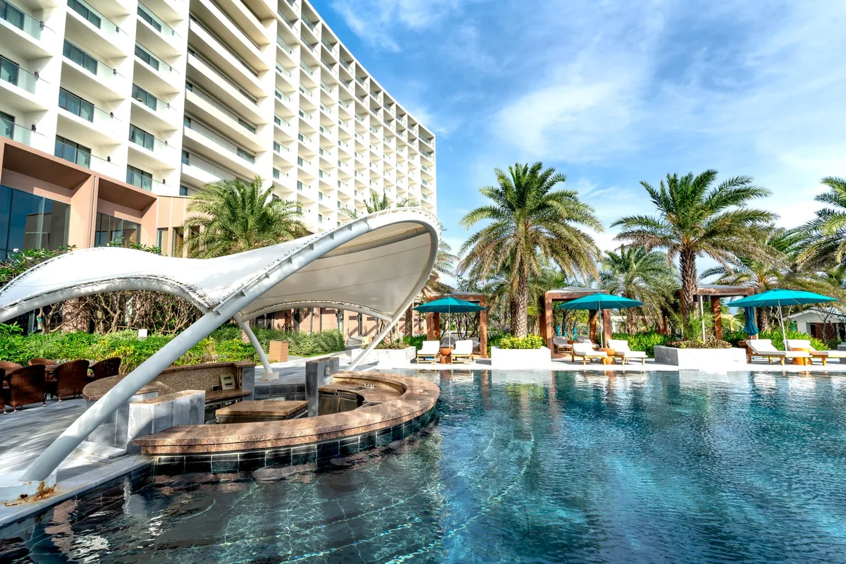 waterfront hotel exterior with outdoor cabanas