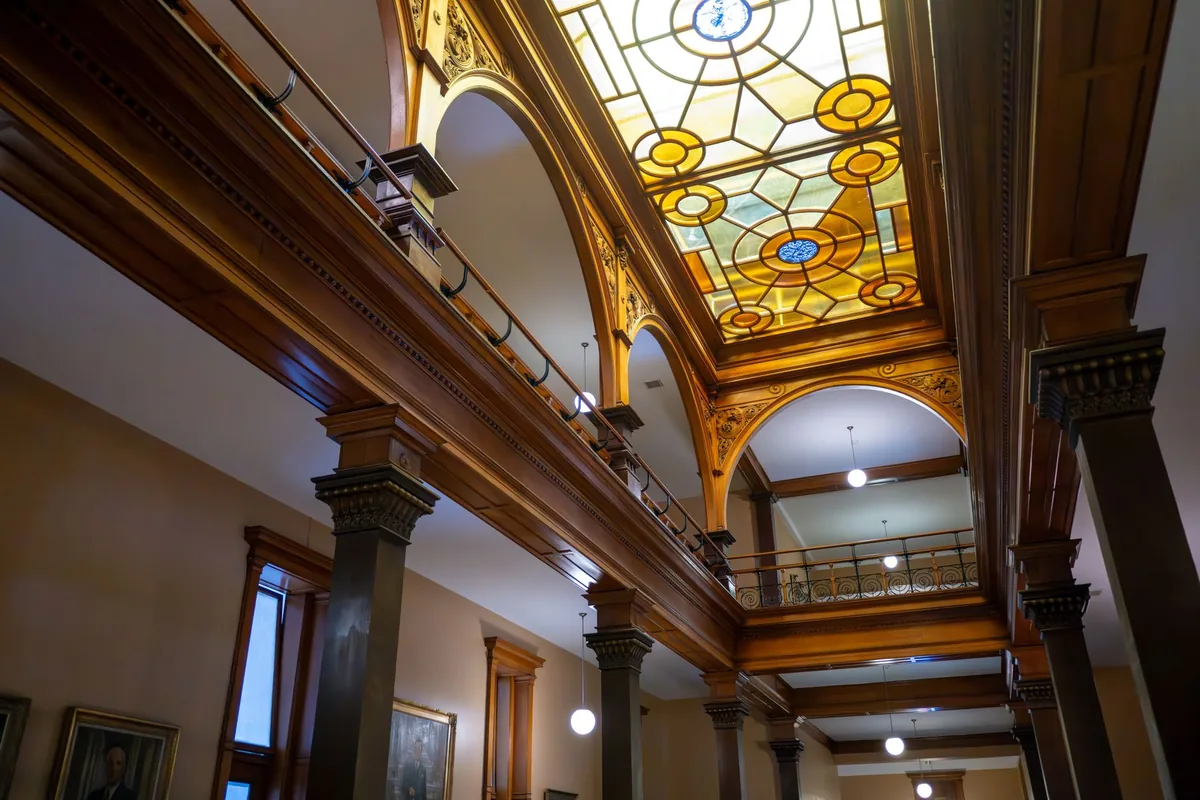 restored hotel interior high ceilings stained glass