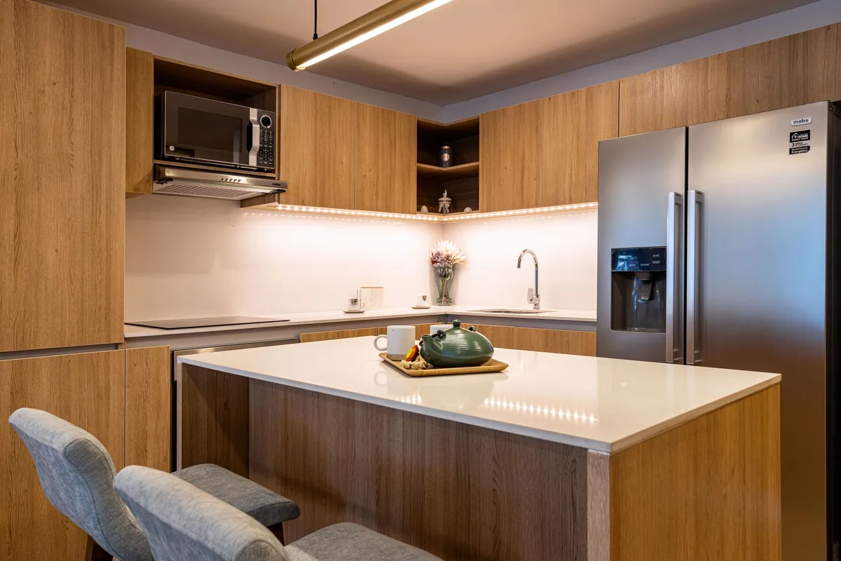 hotel guestroom with full kitchen, full size refrigerator, and microwave