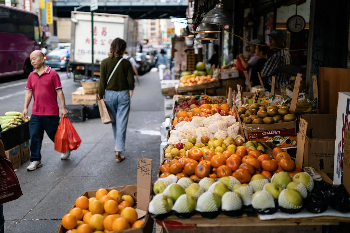 new york city bodega exterior with fruit and flowers