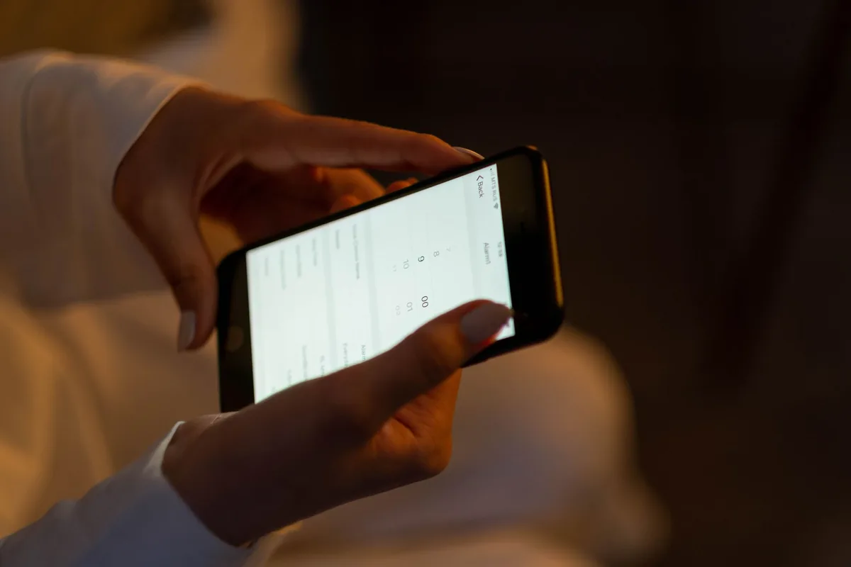 young adult checking into hotel using mobile phone app