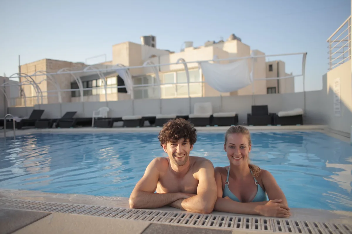friends relaxing by a modern hotel swimming pool