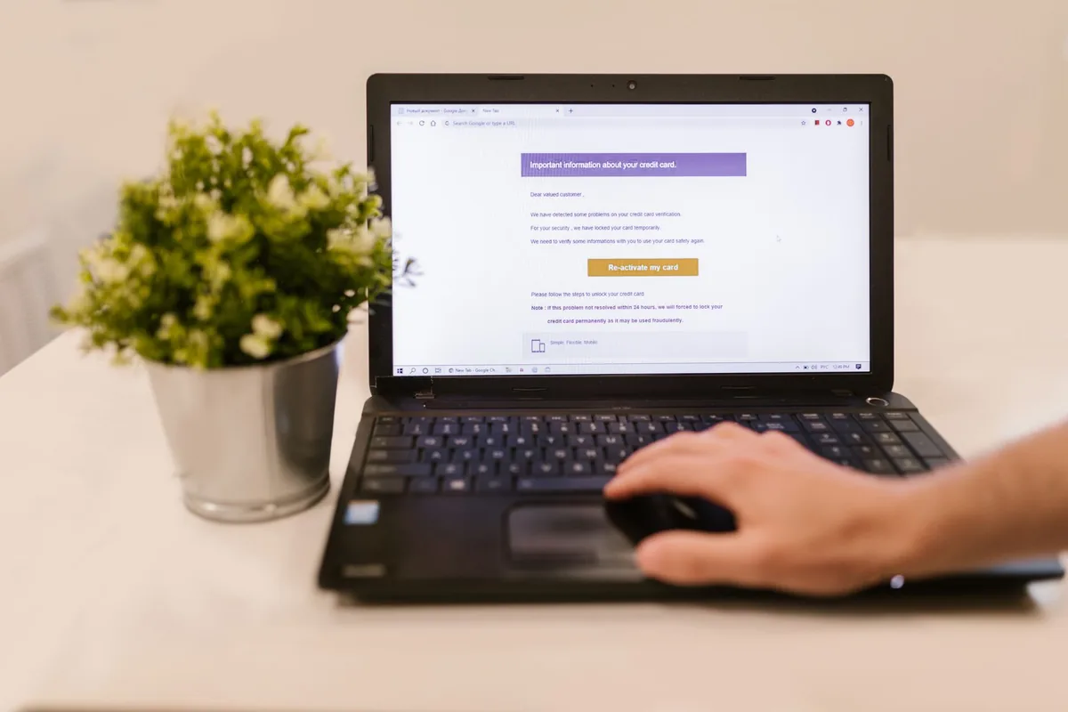 person typing on laptop with flight and hotel reservation emails visible on screen