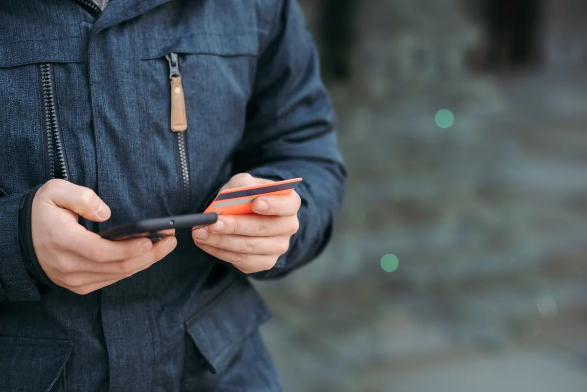 traveler using smartphone payment credit card