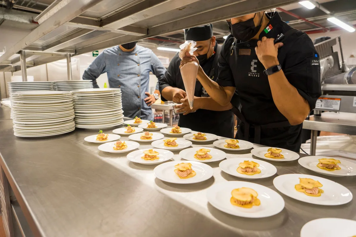 chef preparing dish in upscale commercial kitchen