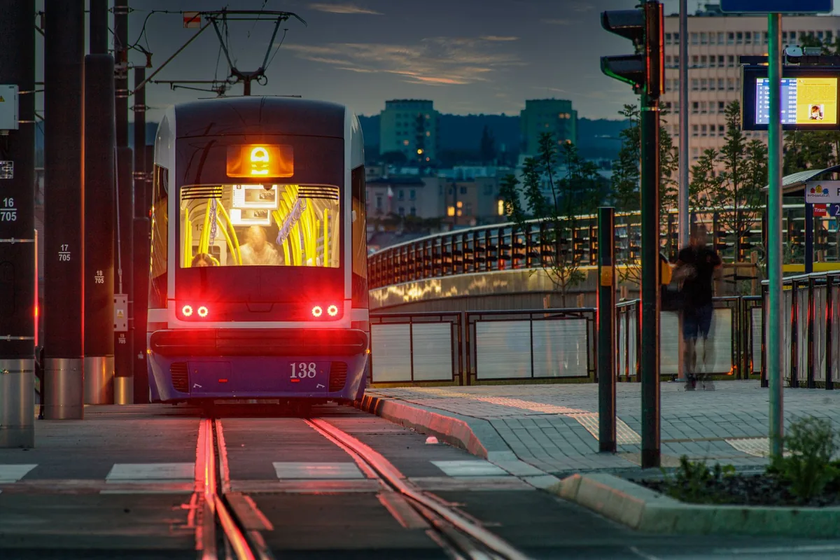 light rail tram approaching modern transit station