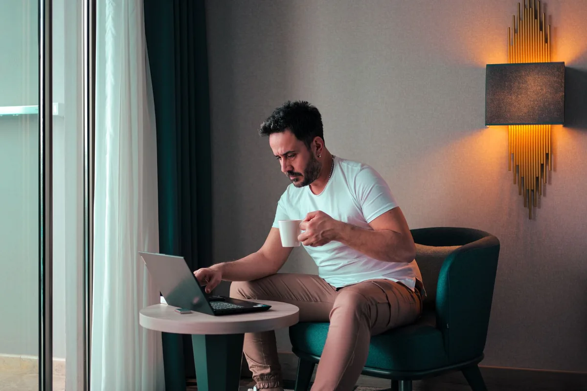 business traveler working hotel room laptop
