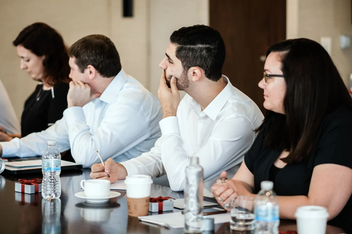 business travelers sitting in a hotel conference room