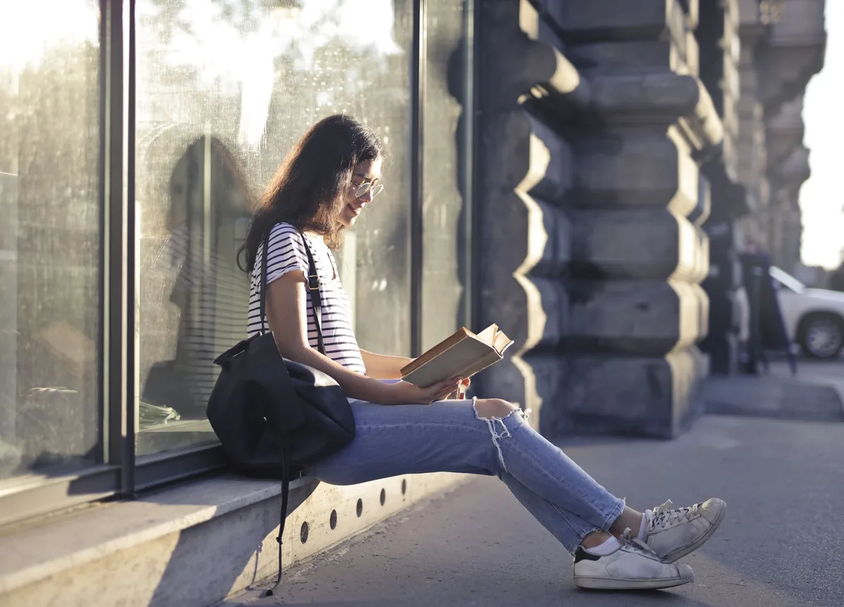 solo traveler reading book on balcony