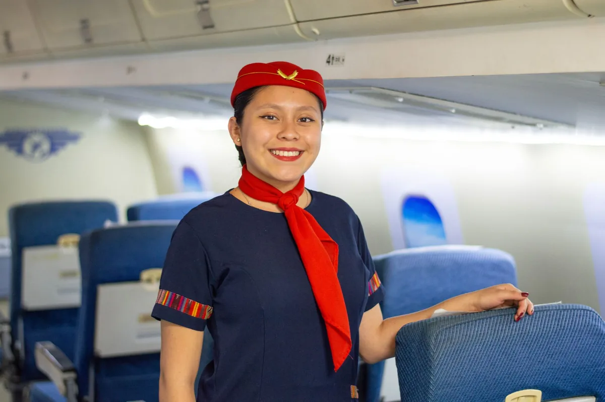flight attendant greeting passenger cabin