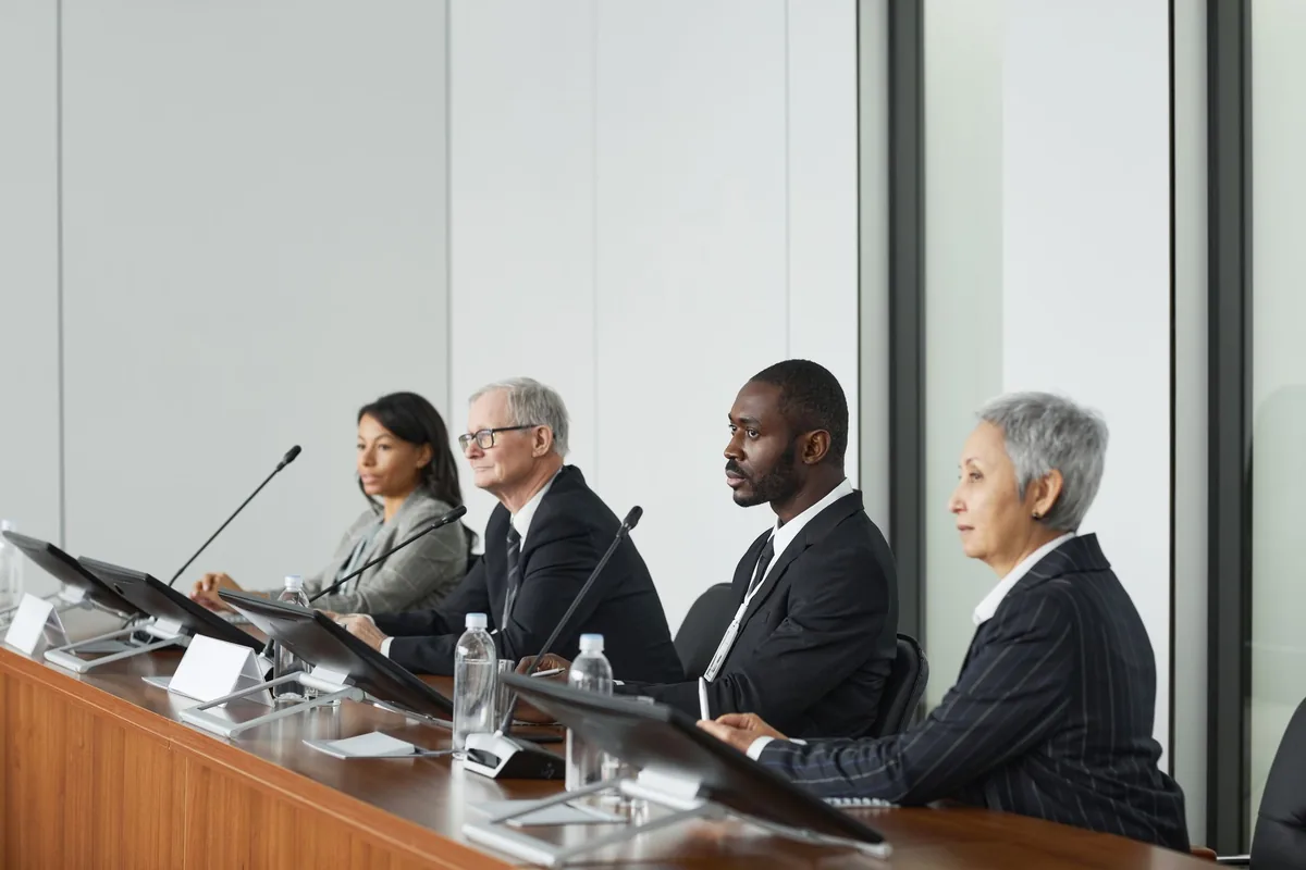 executives sitting at hotel boardroom conference table