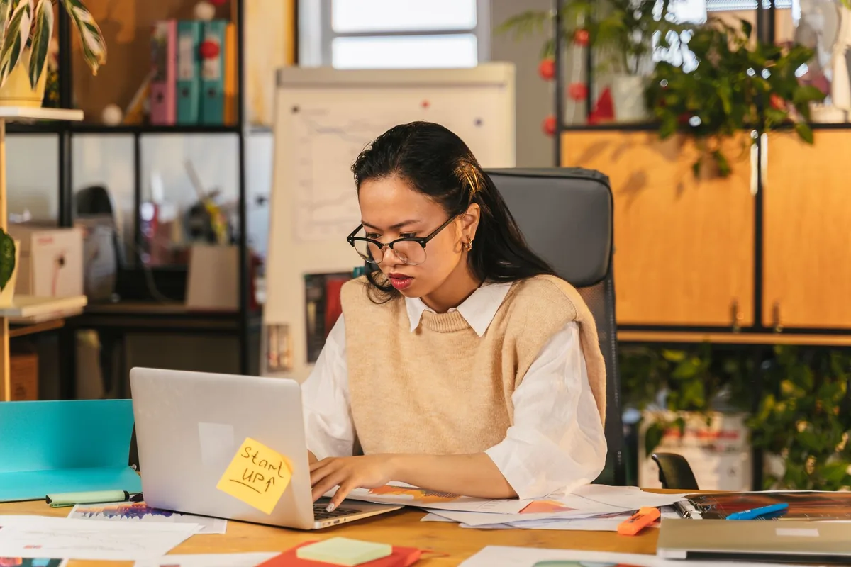 hotel manager working on laptop in modern back office
