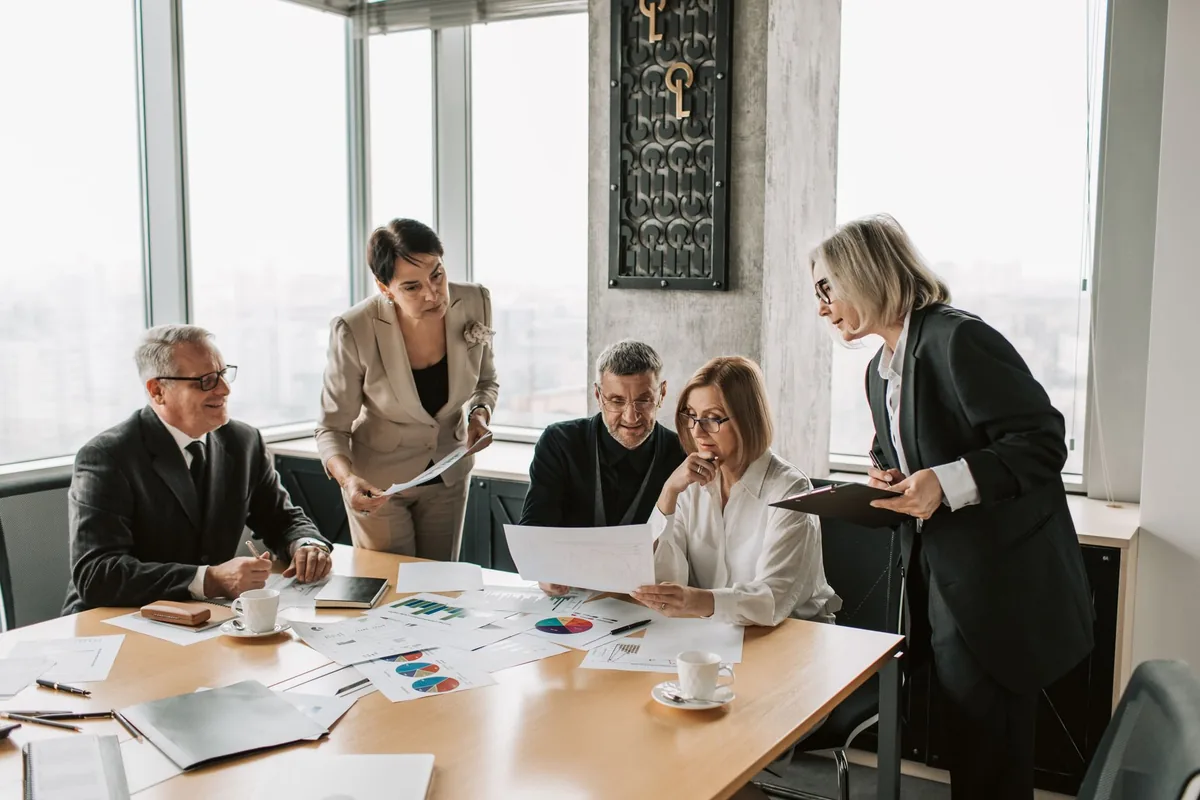 business executives discussing data in hotel meeting room