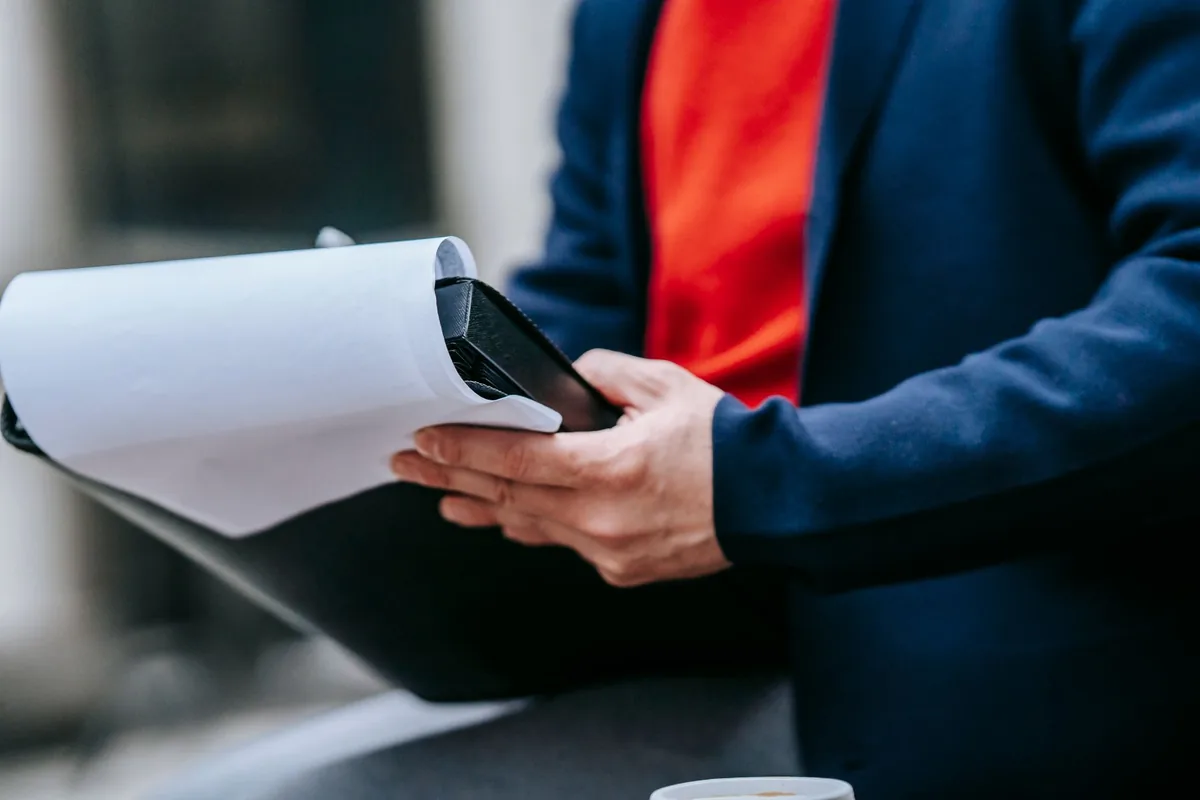 hotel inspector reviewing paperwork clipboard