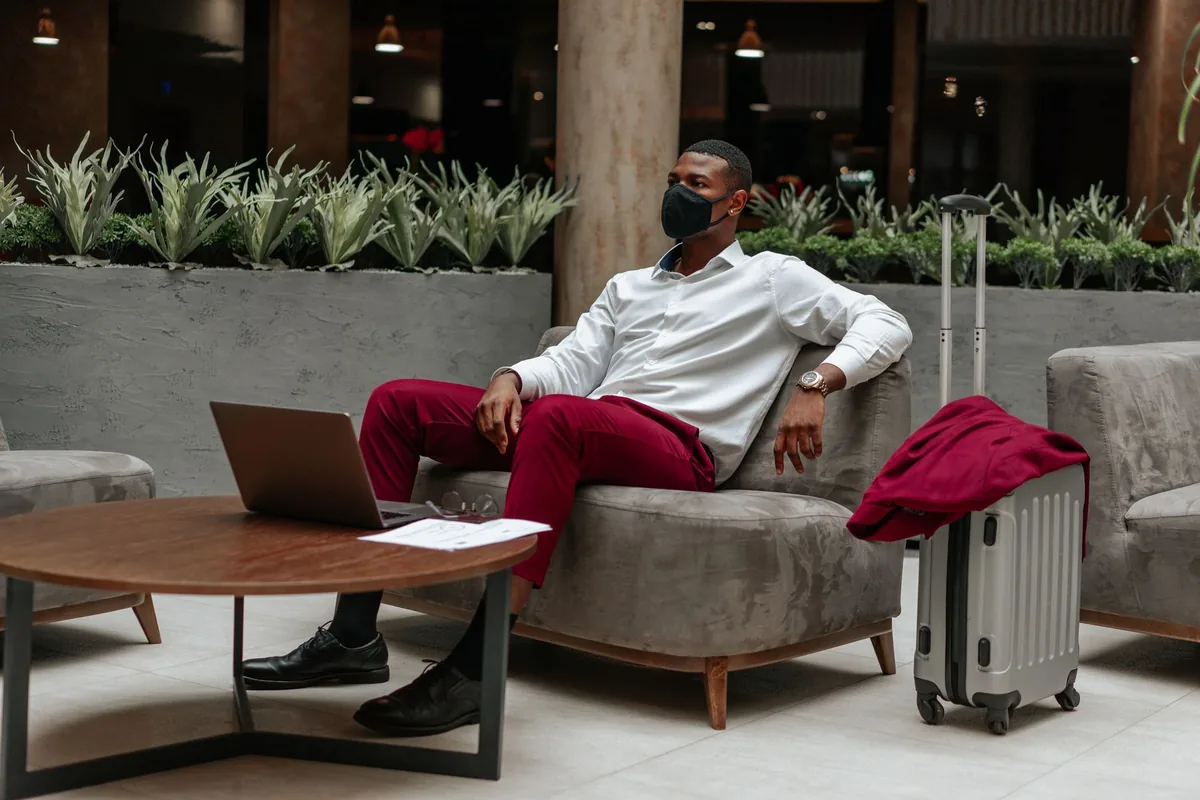 business traveler using laptop in hotel lobby