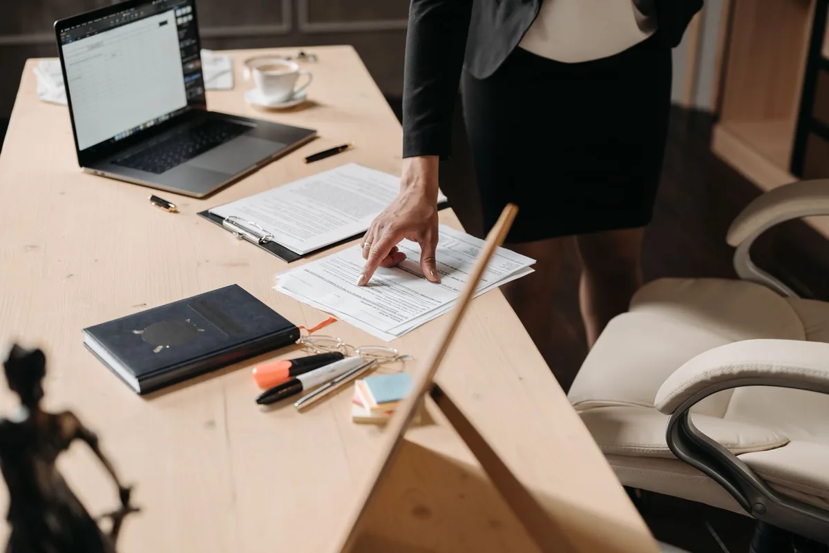 hotel office desk laptop reviewing vendor contract