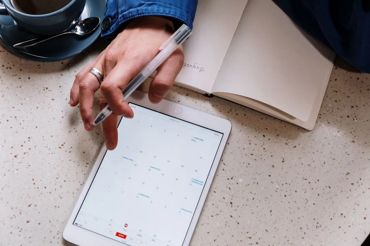 hotel manager organizing schedules on tablet