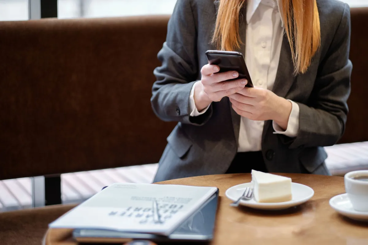 hotel guest using smartphone at table