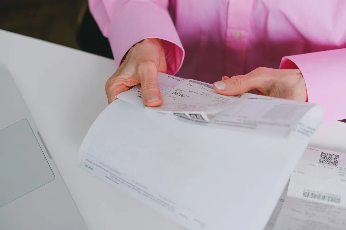 hotel manager reviewing supply invoices on computer