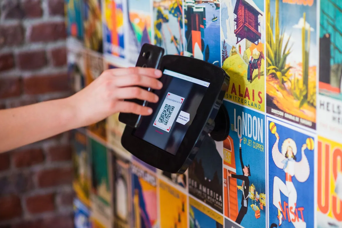 hotel guest scanning QR code with smartphone
