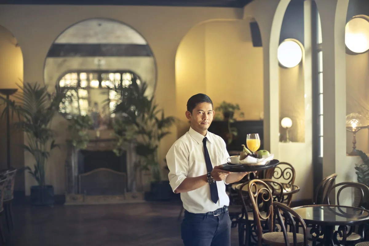 hotel restaurant waiter serving tray